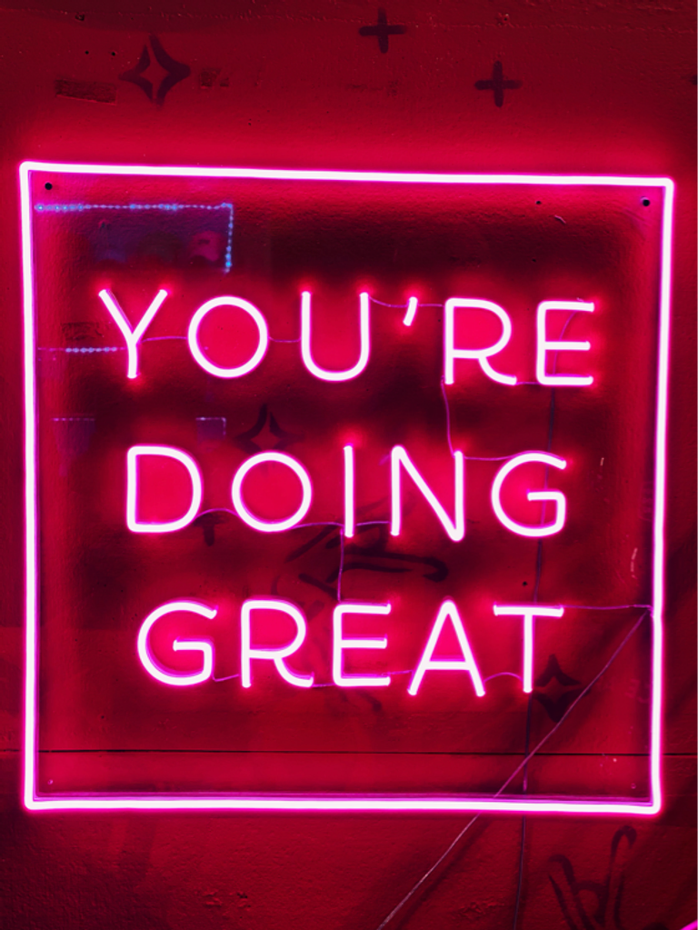 neon sign that says you're doing great